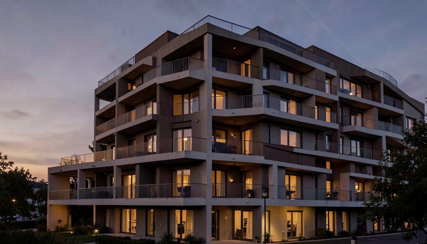 Modern residential block with rhythmic balcony detailing, warm evening light across the facade